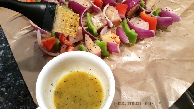 Swordfish kabobs are brushed with citrus sauce before grilling