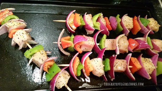 Citrus marinated swordfish kabobs are cooked on griddle.