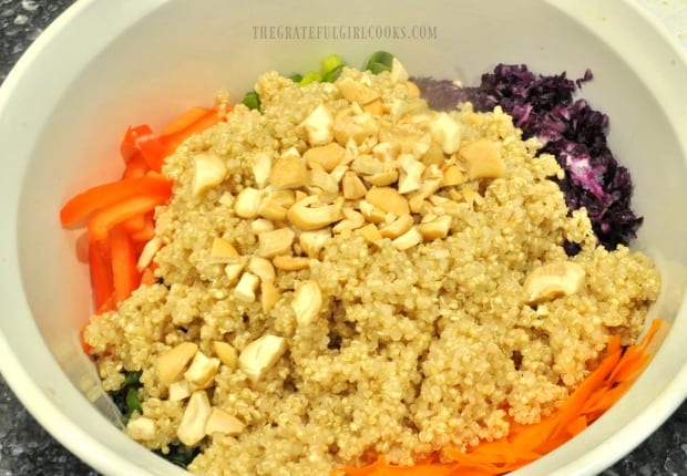 Cooked quinoa and cashews added to Thai salad vegetables.