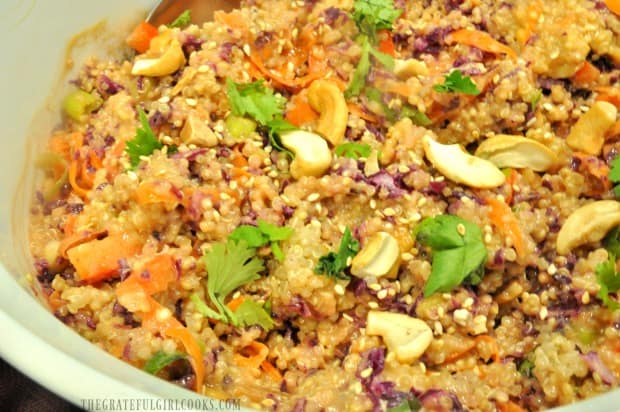 Thai quinoa salad is mixed together, and garnished with sesame seeds and cilantro.