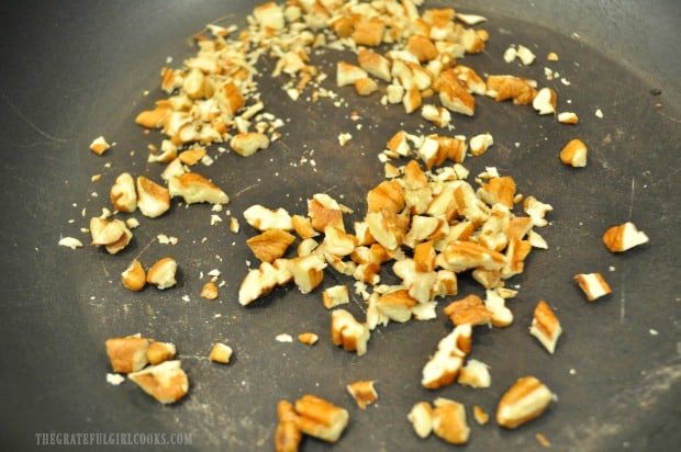 Pecans are lightly toasted in skillet before adding to lemon herb couscous salad.