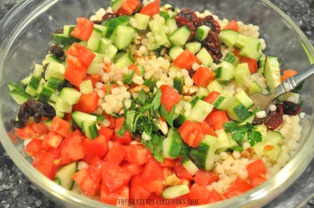 All ingredients have been added to lemon herb couscous salad. Time to mix it all together!