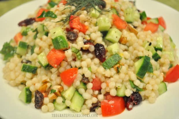 Close up photo of lemon herb couscous salad in white bowl.