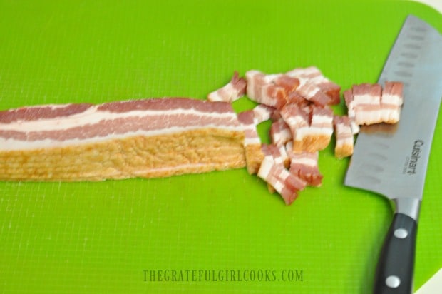 Slicing the bacon up thin to cook, in order to add to tortellini dish.