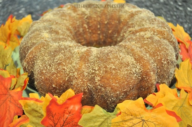 Apple Cider Bundt Cake on green plate, with Fall leaves.