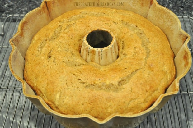 Baked apple cider bundt cake cooling on wire rack before removing from pan.