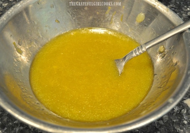 Lemon ginger salad dressing for spiralized carrot salad is whisked, to emulsify it.