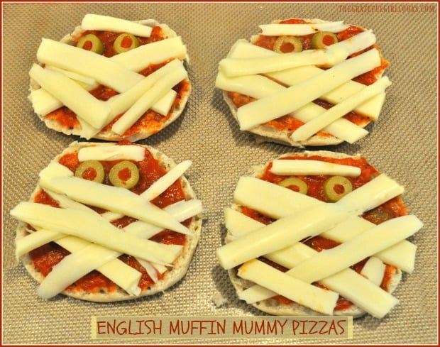 English Muffin Mummy Pizzas are a perfect Halloween treat for kids (or adults)! They're cute, yummy, and VERY EASY to make, with only a few ingredients!