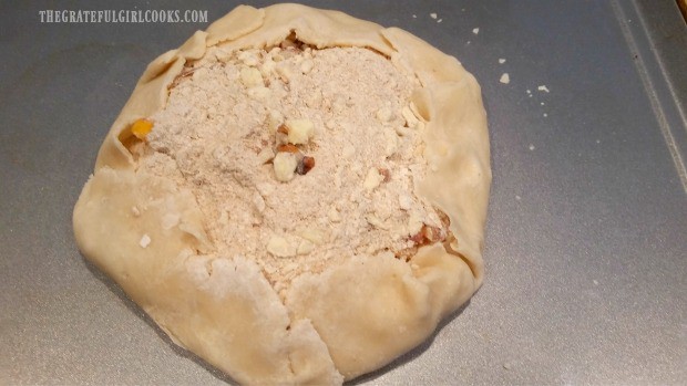 Dough is loosely folded over peach galette filling before it is baked.