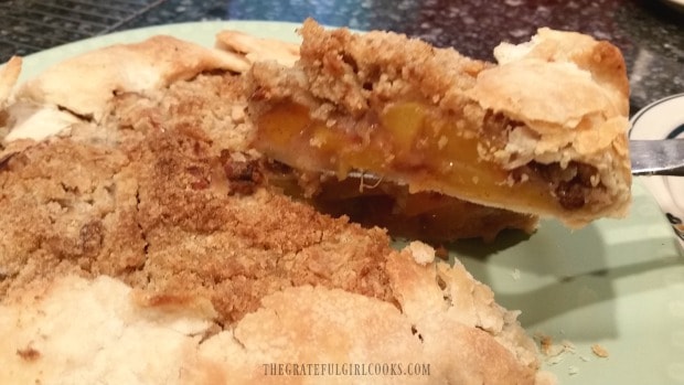 Removing a slice from the peach galette.
