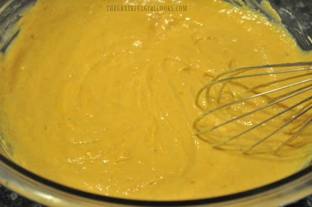 Batter for pumpkin chocolate chip muffins is whisked together.