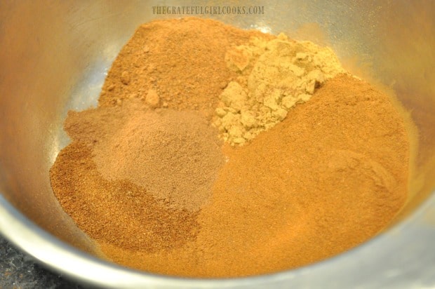Ingredients for pumpkin pie spice mix are placed in a small bowl.