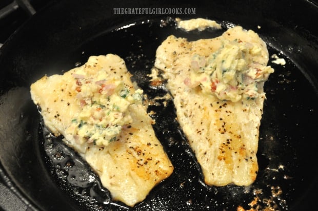 Roast cod is topped with garlic bacon butter, then put into oven to finish cooking.
