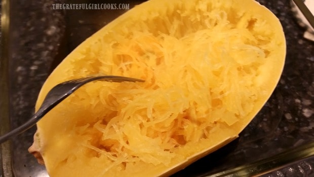 A fork can be used to shred cooked spaghetti squash into strands resembling spaghetti noodles.