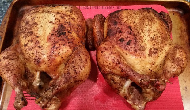 Traeger roasted chicken is done cooking, resting on cookie sheet before slicing.