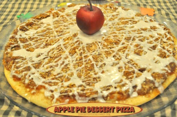 Apple pie dessert pizza features a thin pizza crust, topped with apple pie filling, a brown sugar and oats streusel topping, drizzled with cinnamon icing. 