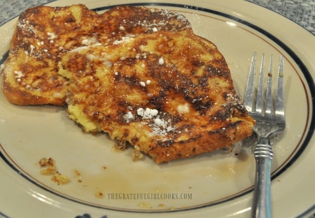 Someone already took a big bite out of the classic french toast on the plate.