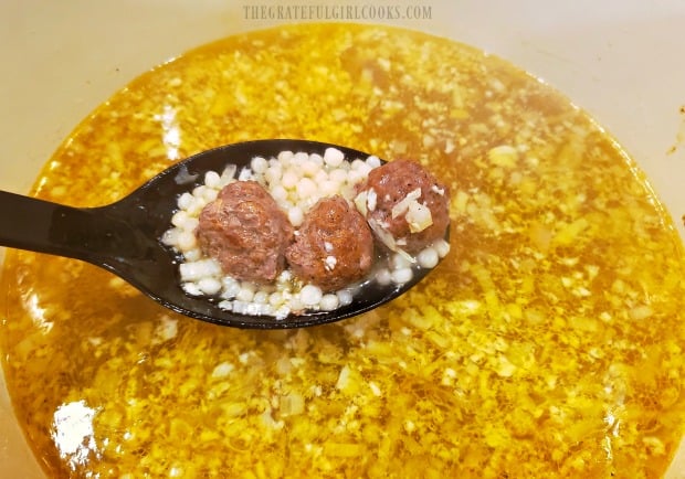 Moroccan meatball couscous soup cooking in broth.