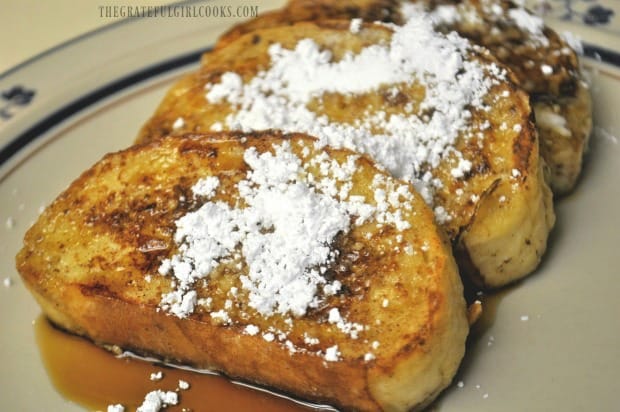 Classic french toast, made with french bread, sprinkled with powdered sugar.