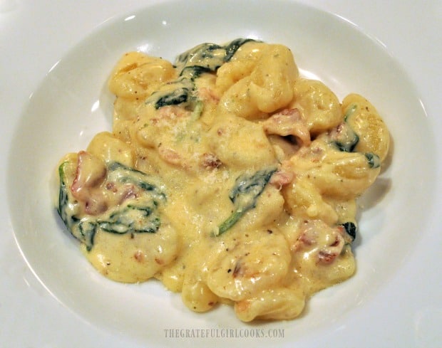 Bacon parmesan spinach gnocchi is served in a white bowl.