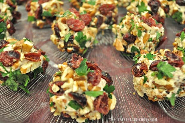 Close up photo of cranberry pecan goat cheese bites, on plate.