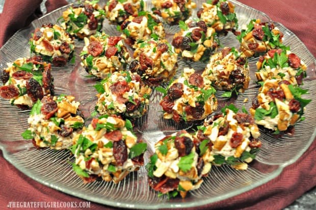 Cranberry pecan goat cheese bites are on a plate.