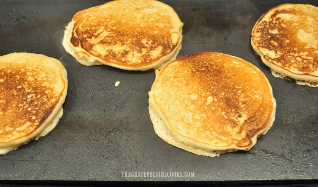 The apple pie pancakes are turned when nicely browned, to finish cooking.