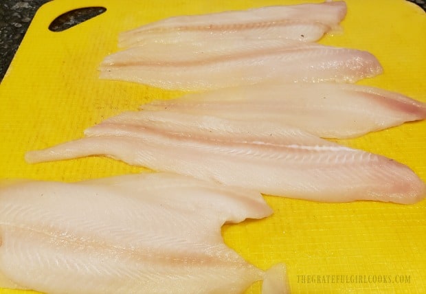 Dover sole fillets are patted dry before adding the seasoning.