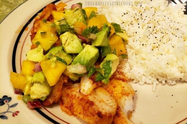 Dover sole fillets with mango avocado salsa are served, with rice on the side.