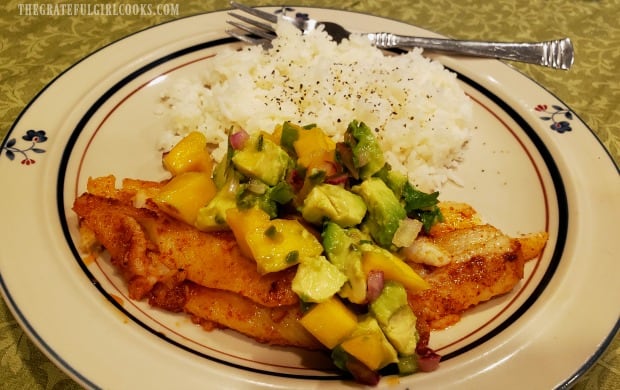 The cooked dover sole fillets are topped with mango avocado salsa to serve.