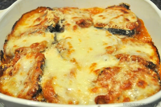 Eggplant parmesan, freshly baked, with gooey melted cheese on top.