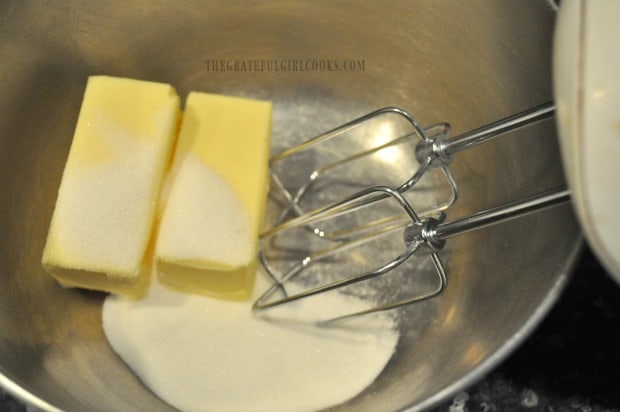 Butter and sugar are beaten together to make dough for cookies.