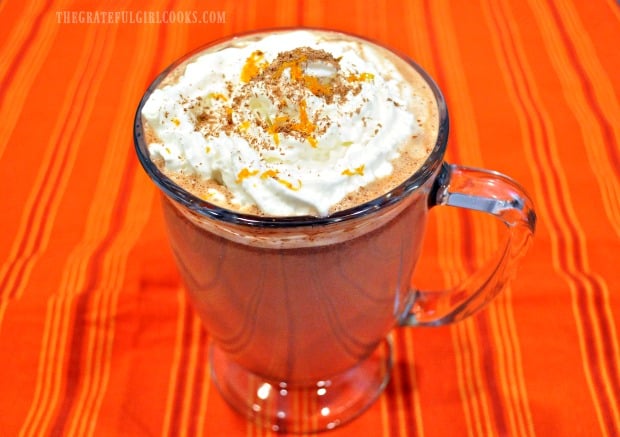 Once hot, Valencia orange hot chocolate is put in mugs, and topped with whipped cream and orange zest.