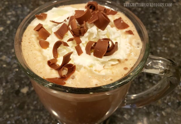 Valencia orange hot chocolate can be topped with whipped cream and chocolate curls.