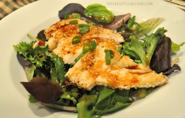 A side view of the ginger chicken salad with ginger dressing in white bowl.