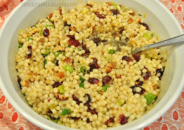 The cranberry orange Israeli couscous is served, in a white bowl.