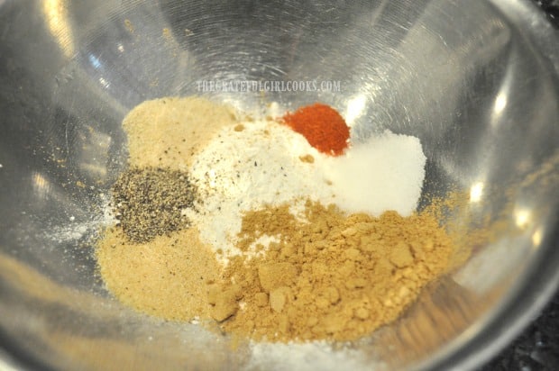 Spices are mixed to apply to chicken wings, before baking.