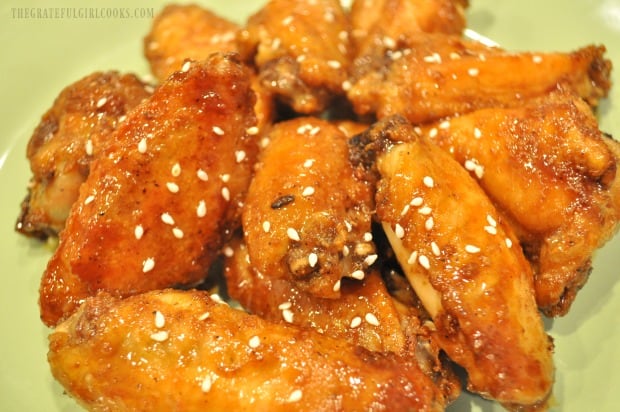 The baked Asian chicken wings are served, garnished with sesame seeds.