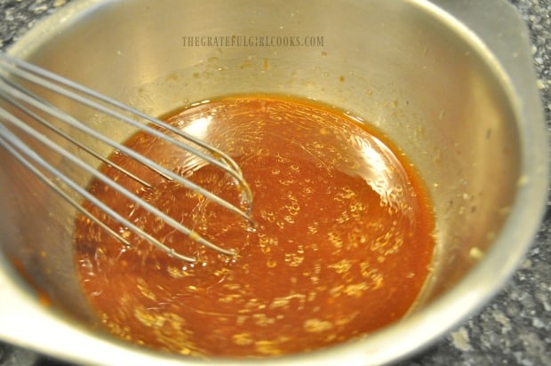 Sauce is mixed to put on baked Asian chicken wings, after they finish cooking.