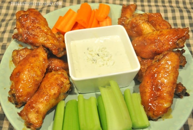 A platter of buffalo honey hot wings, served with bleu cheese dressing, celery and carrots.