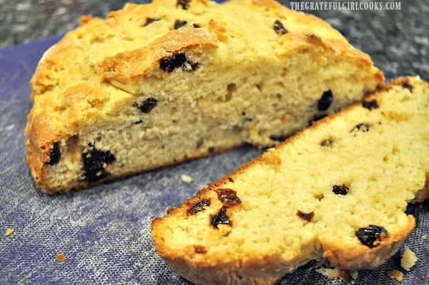 A slice is cut out of the Irish soda bread, to reveal the inside of the loaf.