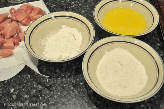 Pork cubes and bowls with corn starch, eggs, and flour are ready to make sweet and sour pork!