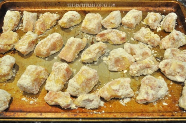 Pieces of pork are fully coated and are now ready to fry, to make sweet and sour pork.