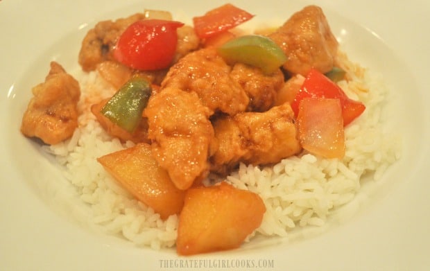Sweet and Sour Pork is served on top of rice, and is ready to eat.