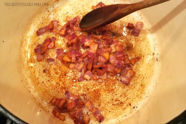 Bacon is cooked until crispy, before adding to fried cabbage.