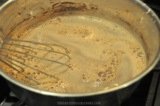The mixture for the homemade chocolate pudding is brought to a boil to thicken.