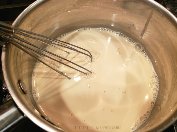 Evaporated milk and brown sugar are cooked until sugar is dissolved.
