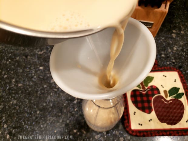 The Créme Brulee Coffee Creamer is poured though a funnel into storage container.