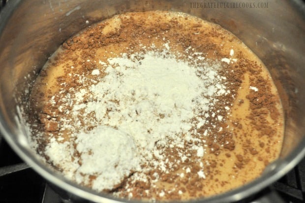 Cocoa, milk, sugar, cornstarch and salt are mixed and heated in pan to make homemade chocolate pudding