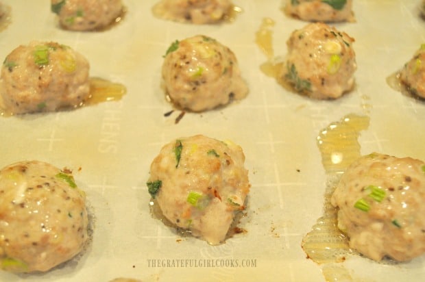 When the Thai turkey meatballs are halfway through baking, they are flipped to other side.